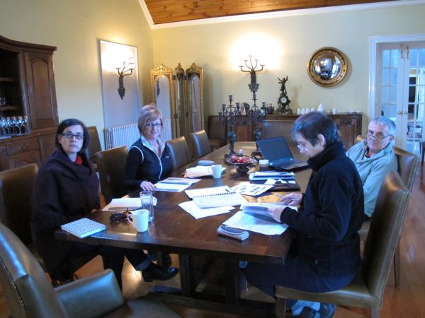 Photo of 4 researchers working together at a large table