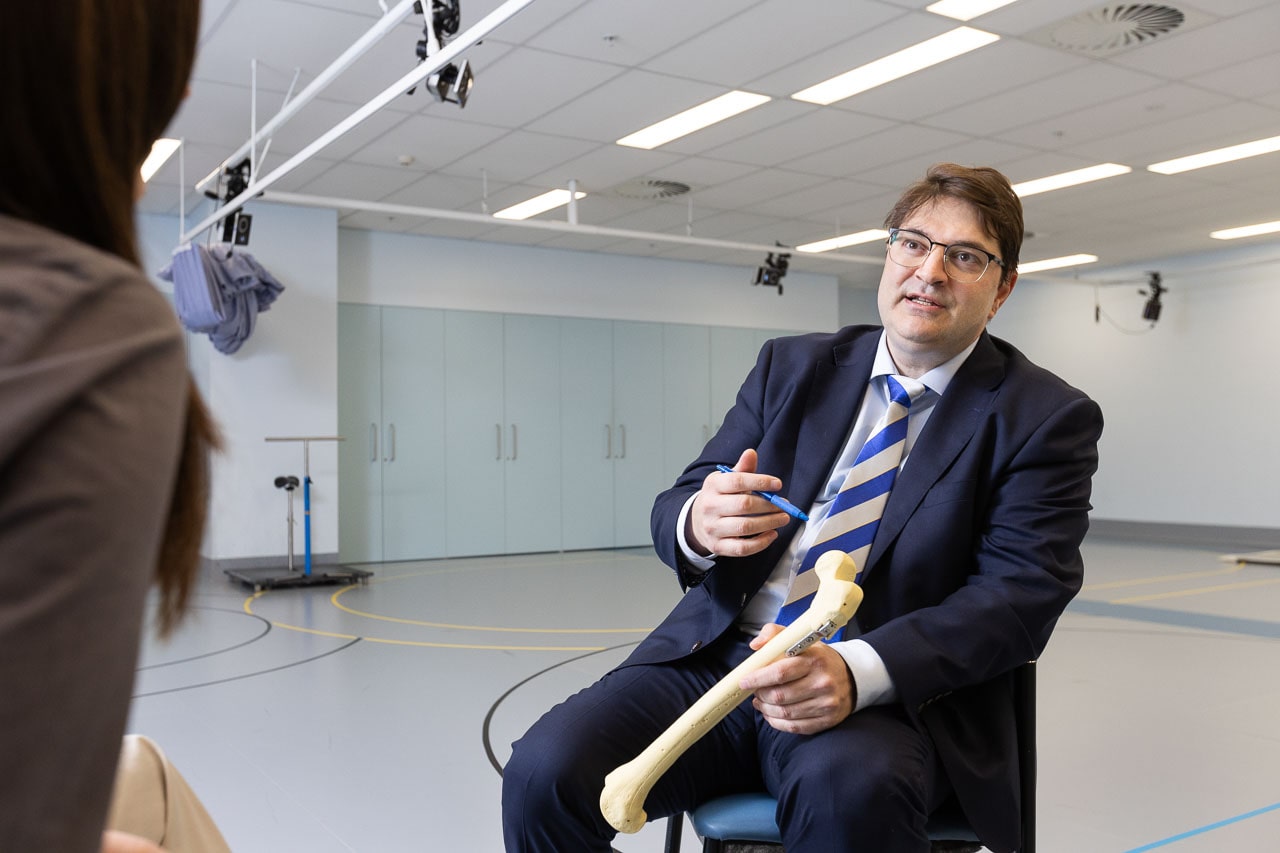 Associate Professor Erich Rutz sits in the Hugh Williamson Gait Analysis Laboratory at the Royal Children’s Hospital, holding an anatomical model of a femur in his left hand. He points to the model using a pen in his right hand