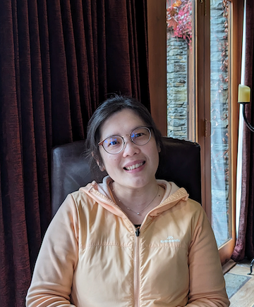Teresa in pale orange jacket smiling