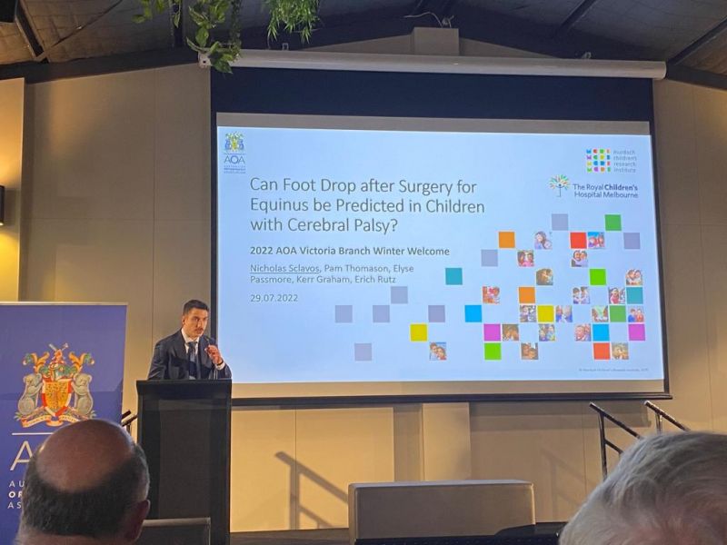 Nicolas Sclavos presenting in front of his title slide which reads: "Can foot drop after surgery for equinus be predicted in children with cerebral palsy?"