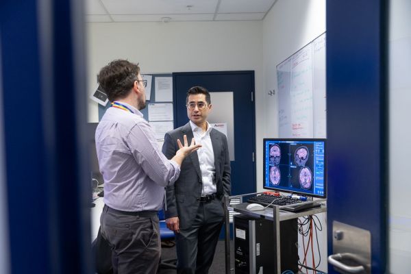 Professor Perucca discusses brain scans with colleague Michael Ginevra