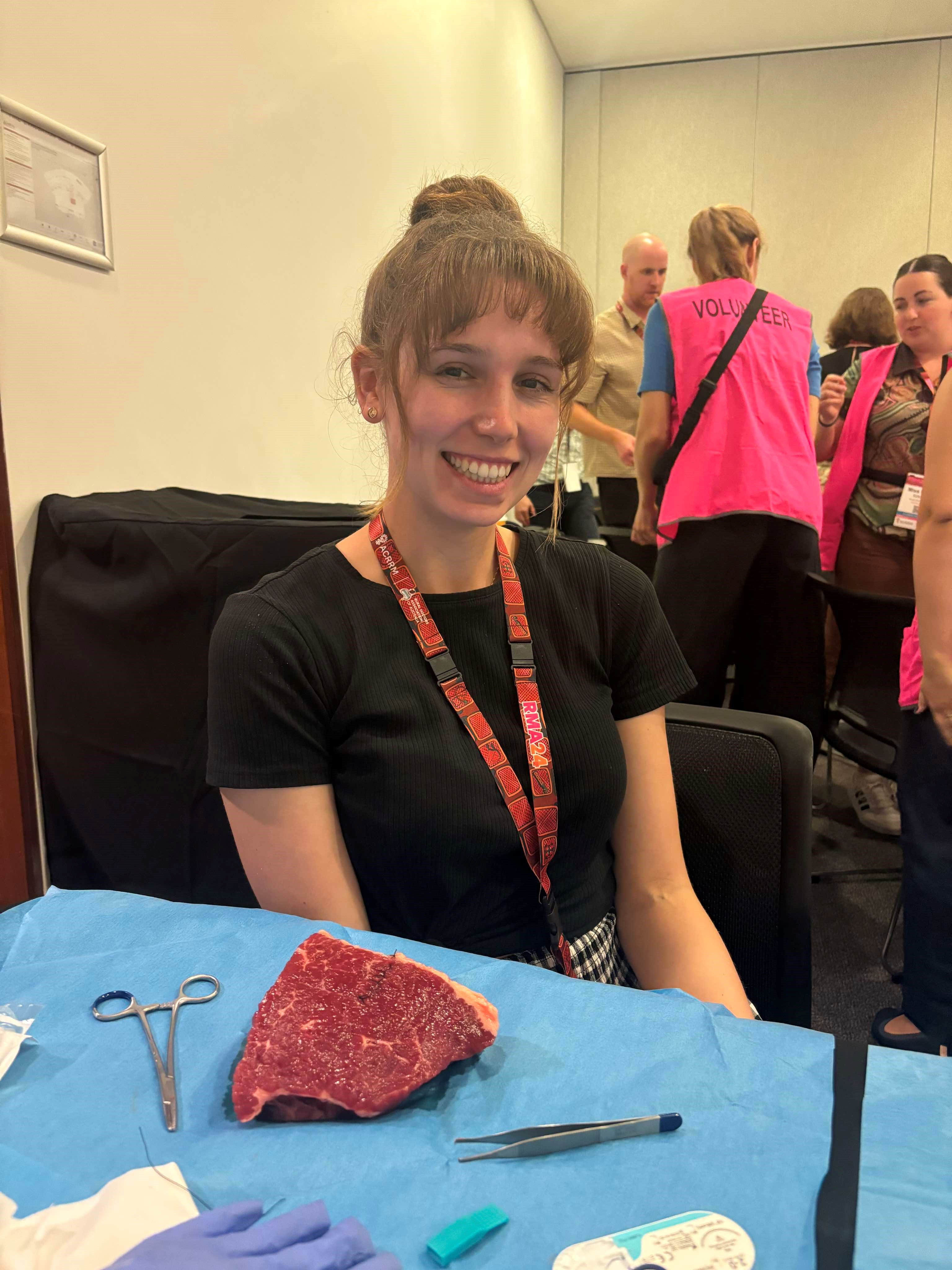 Student smiling practicing medical skills