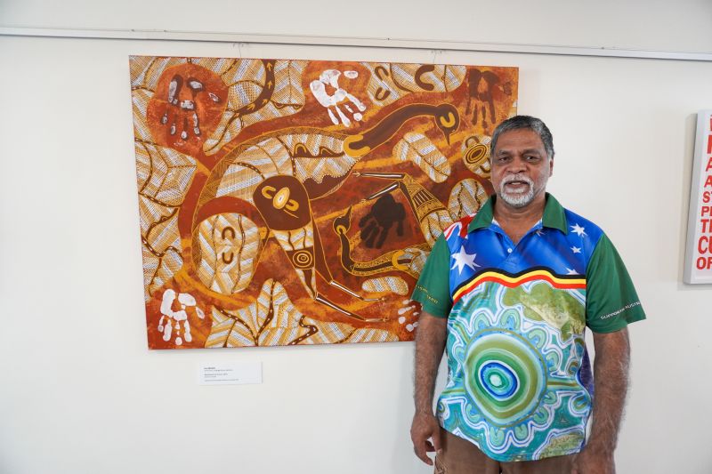 Eric Brown in front of his artwork at the Departmen of Rural Health in Shepparton