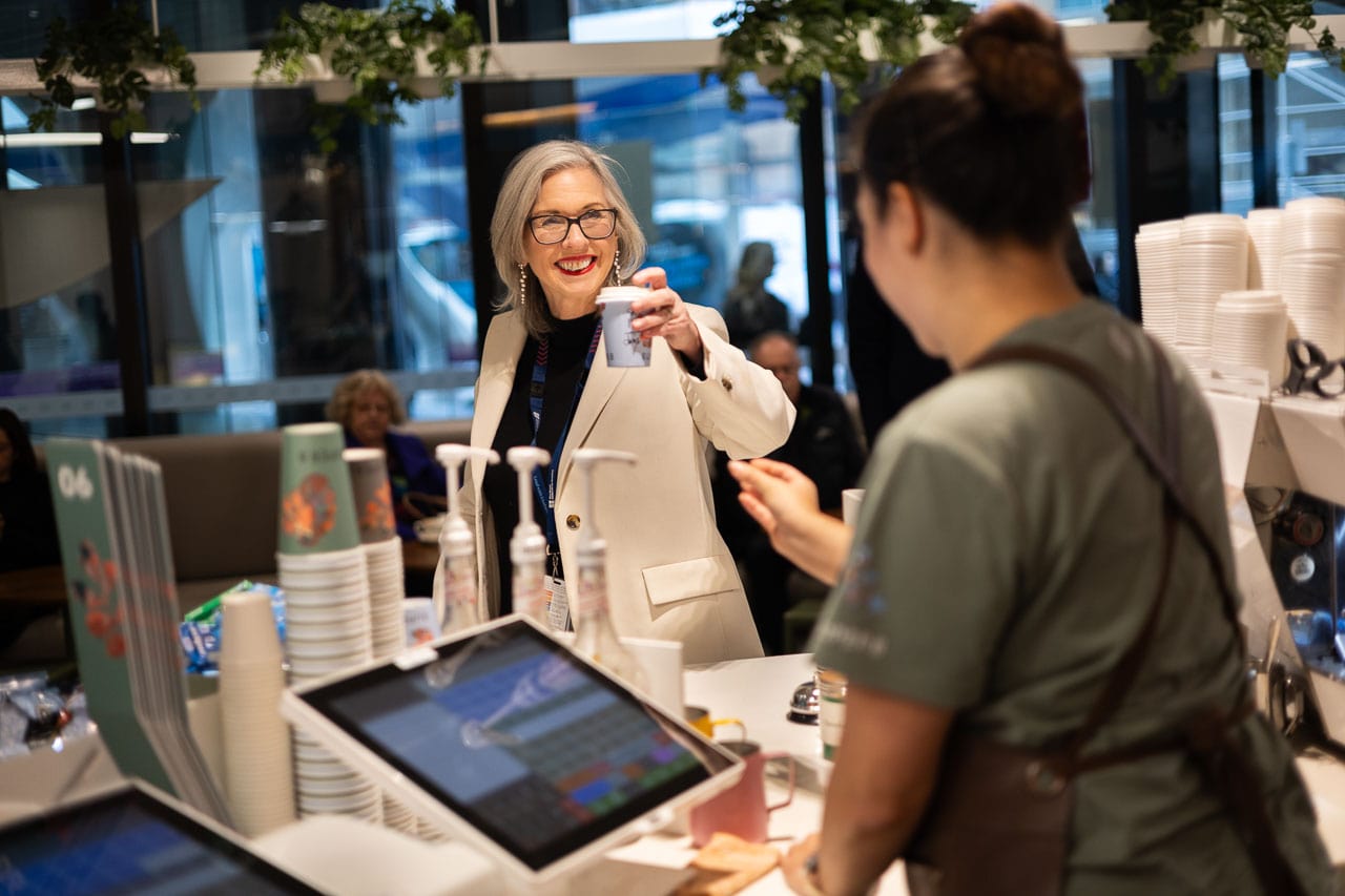 Professor Christobel Saunders buys a coffee at the Super8 cafe on the ground floor of the Peter MacCallum Cancer Centre
