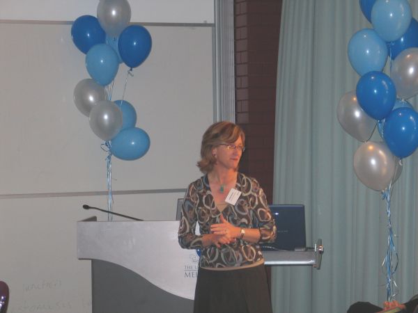 Jane Gunn standing in front of a University of Melbourne lectern